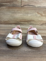 Pink and white baby girl shoes with bows on wooden floor, kids footwear