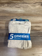Overhead view of folded Gerber beige onesies pack showcasing blue band labeled 5 onesies on wood background