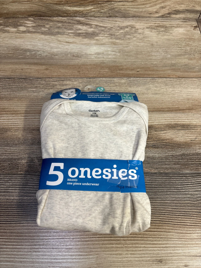 Overhead view of folded Gerber beige onesies pack showcasing blue band labeled 5 onesies on wood background