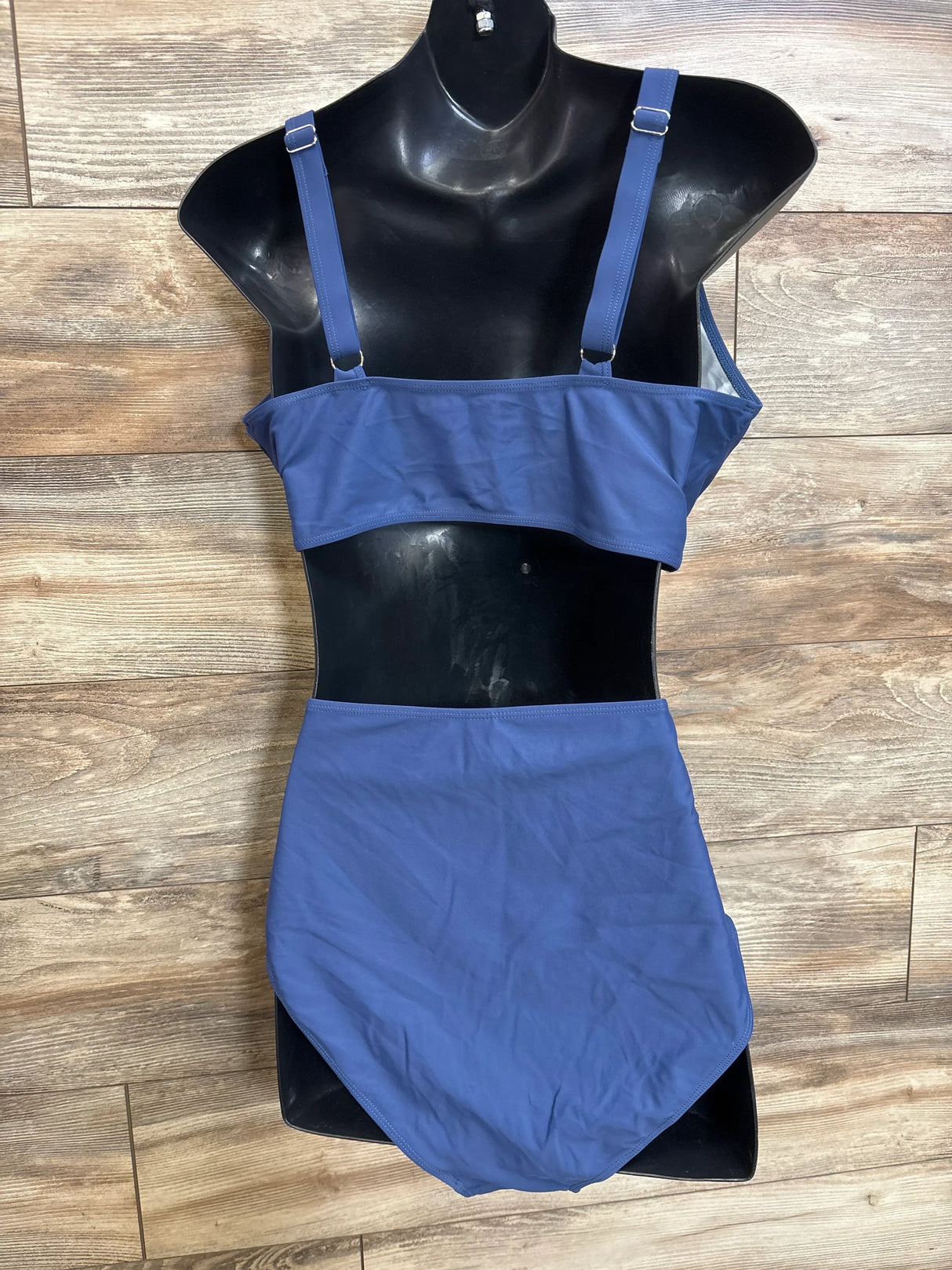 Front view of navy maternity two-piece swimsuit on black mannequin, showing adjustable straps and high-waist bottoms