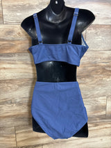 Front view of navy maternity two-piece swimsuit on black mannequin, showing adjustable straps and high-waist bottoms