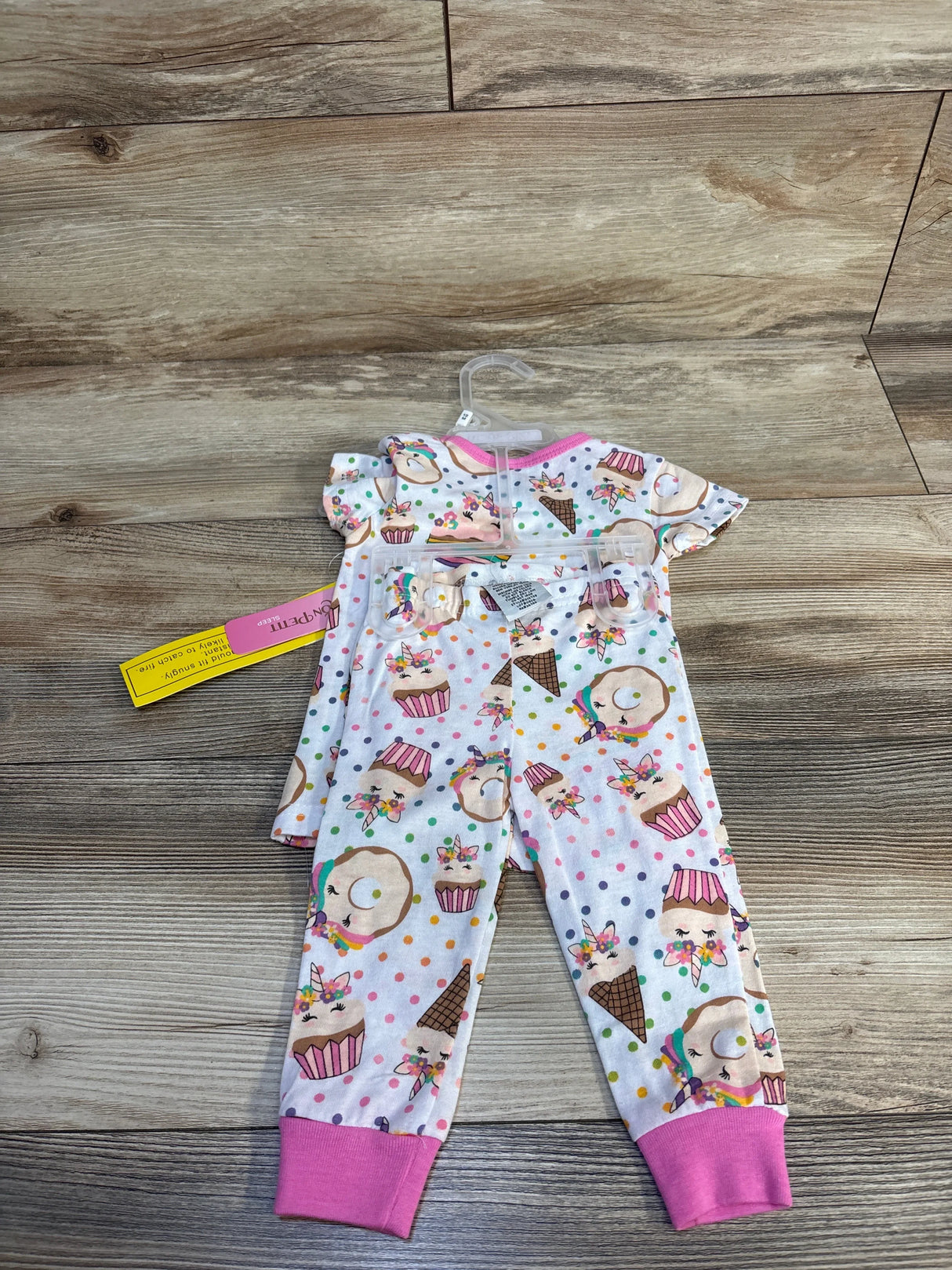 Adorable unicorn and cupcake print baby pajamas set with pink cuffs, perfect for toddler sleepwear.