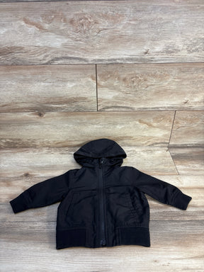 Black kids hooded jacket with zipper, laid flat on wood floor for resale
