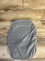 Top-down view of BlueSnail bassinet sheet showing grey heathered stretchy knit fabric and fitted oval shape on wood background