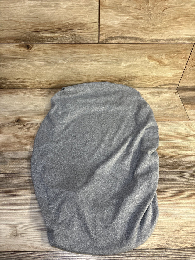 Top-down view of BlueSnail bassinet sheet showing grey heathered stretchy knit fabric and fitted oval shape on wood background