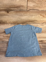 Back view of Children's Place blue toddler T-shirt (4T) showing short sleeves and crew neck on wood background