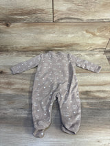 Flat lay of beige Ecojoy kimono footed sleeper showing front kimono snap closure and white Mama's Bestie star print on wood background