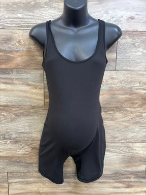 Front view of black Isabel maternity active romper showing scoop neckline, fitted belly and mid-thigh shorts on wood background