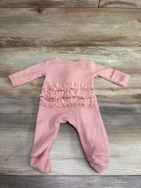 Front view of Weebloom pink waffle knit footie sleeper, newborn size, showcasing ruffles and enclosed feet on wood