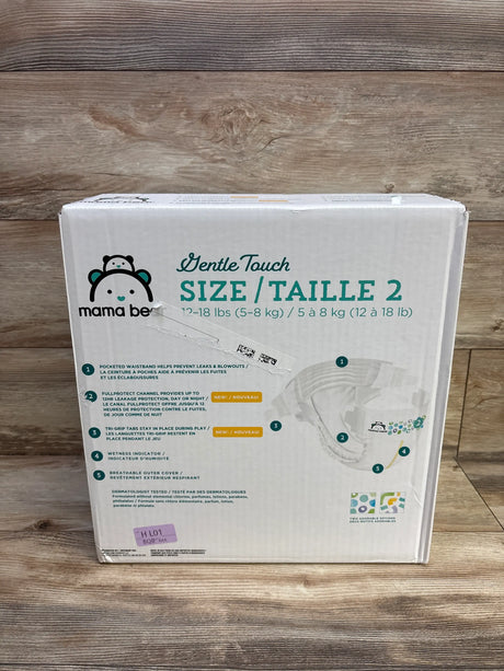 Front view of Mama Bear Gentle Touch diapers size 2 package showcasing leak protection features on a wood background