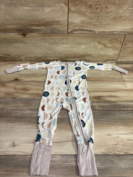 Front view of white Little Sleepies Moon Phases convertible sleeper with moon print, zipper, and fold-over cuffs on wood flooring