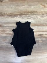 Flat lay of Jordan tank bodysuit back view showcasing ribbed knit fabric and sleeveless armholes on light wood background
