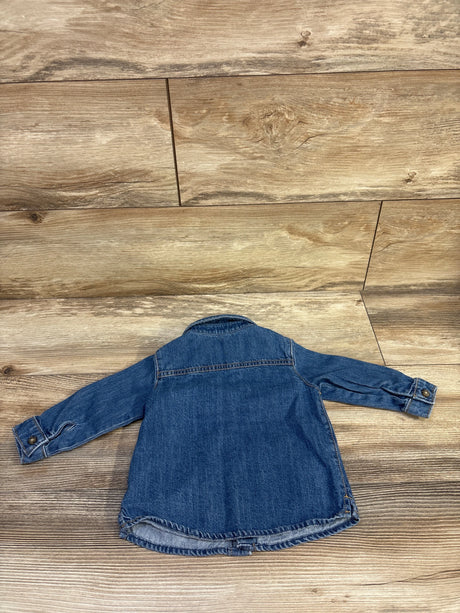 Back view of Carter's denim jacket (9m) showing long sleeves, button cuffs, and frayed hem on wood background