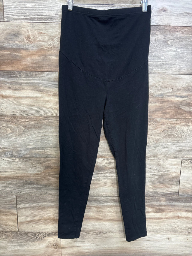 Front view of black Time and Tru maternity leggings showing high-rise maternity panel and full-length legs on wooden floor background