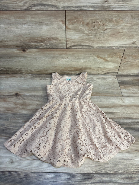 Flat lay of Lily Bleu beige lace girls dress size 4T showcasing scalloped hem and floral lace on light wood background