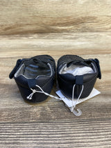 Back view of navy infant fisherman sandals showing heel loop, Velcro strap and attached size tag on wood background