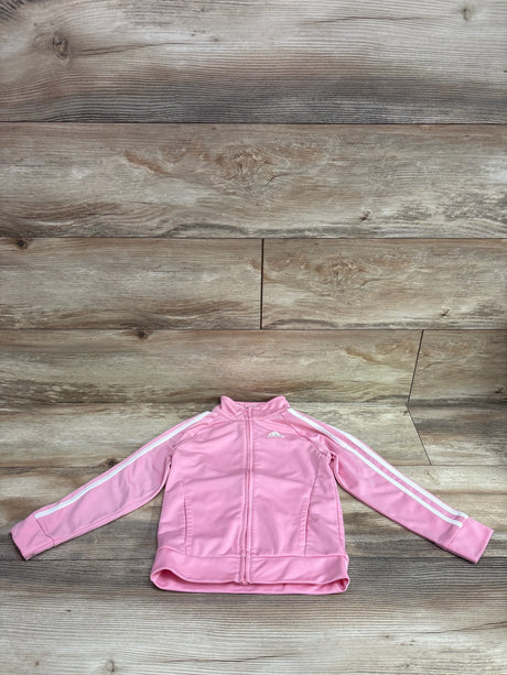 Pink Adidas track jacket for toddlers with white stripes on sleeves, laid on a wood background.