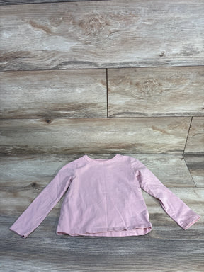 Flat lay of H&M toddler long-sleeve light pink shirt showcasing crew neck, long sleeves, and straight hem with wood floor background, size 3T