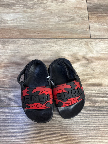 Top view of toddler And1 red camo slide sandals showcasing embossed AND1 logo on the strap with wood-look floor background