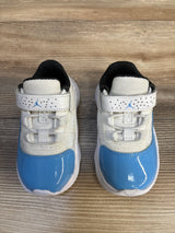 Baby blue and white sneakers with Velcro straps on wooden background, kids athletic shoes
