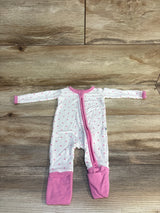 Pink polka dot baby onesie with zipper, laid flat on wood floor