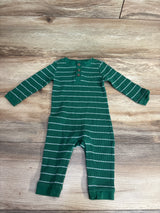 Green and white striped long-sleeve baby onesie with buttons on wooden floor
