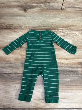 Green and white striped long-sleeve baby onesie with buttons on wooden floor