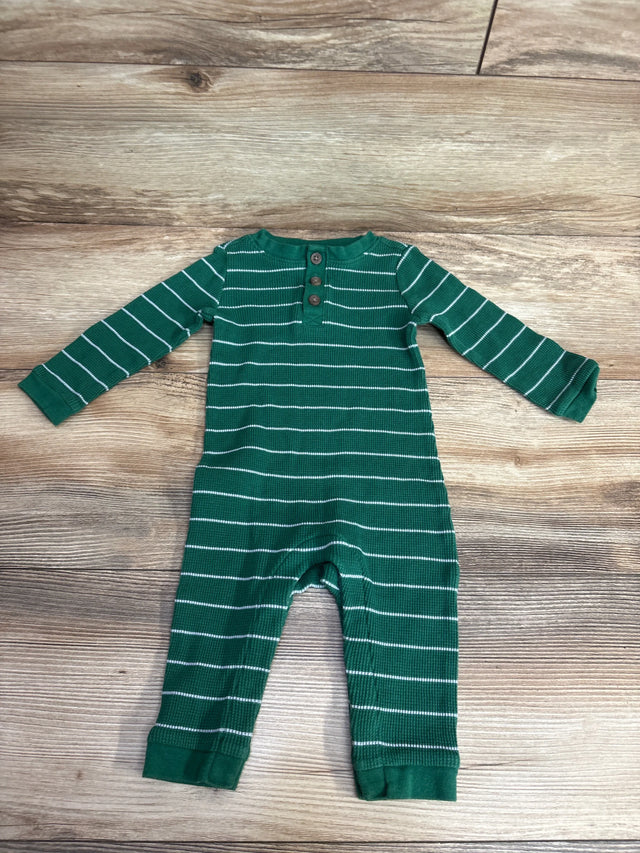 Green and white striped long-sleeve baby onesie with buttons on wooden floor