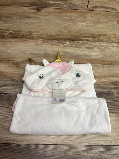 Front view of a cream unicorn hooded towel for infants showcasing ears, gold horn, pink mane, and face details on a wood-grain background