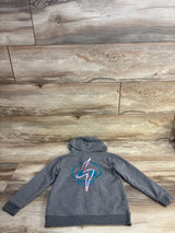 Gray kids hoodie with blue skull and pink lightning bolt graphic on back, laid on wood floor