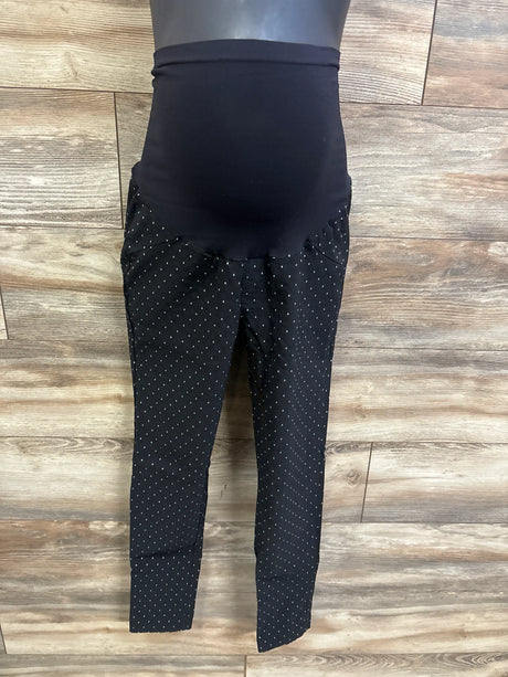 Front view of Motherhood Maternity full panel black pants with over-belly panel, tapered legs, white dot print on wood