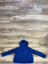 Back view of a blue knitted hooded sweater for kids on wooden floor background
