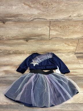 Top-down view of Samara navy velvet top and matching tulle skirt showing star applique and glittery tulle on wood background