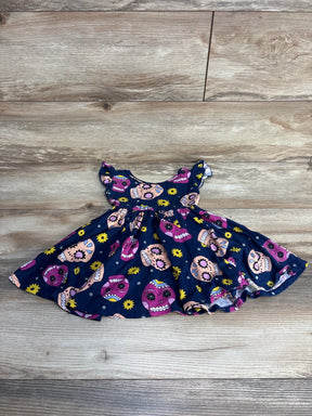 Navy blue toddler dress with colorful sugar skull and yellow flower print on wood floor