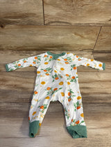 Front view of Burt’s Bees Baby organic sleeper in white with citrus print, front zipper, and green cuffs on wood flooring