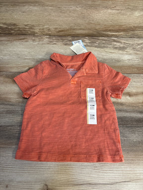 Cat & Jack 12M coral short sleeve polo shirt for baby boys, laid flat on wood surface