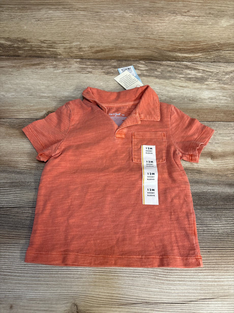 Cat & Jack 12M coral short sleeve polo shirt for baby boys, laid flat on wood surface