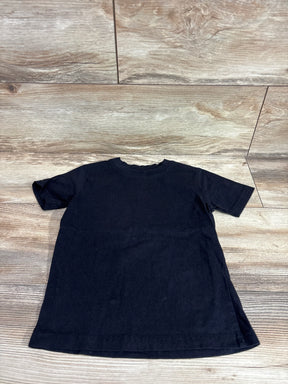 Flat lay of black French Toast toddler short-sleeve shirt showing crew neckline and hem on light wood floor background