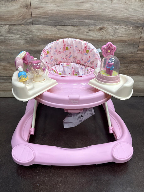 Front view of Disney Music & Lights Baby Walker in Happily Ever After showcasing pink padded floral seat and activity toys with a wood backdrop