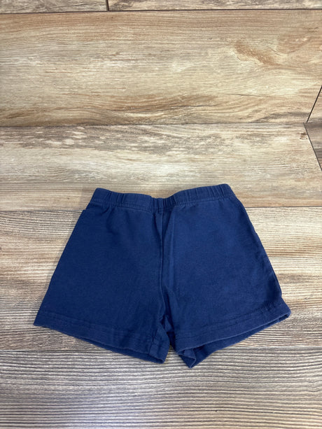 Front view of navy Carter's toddler bike shorts showing elastic waistband and hemmed legs on wood background