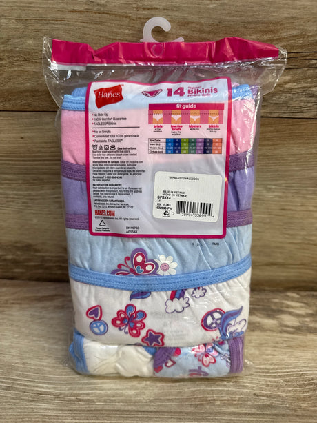 Front view of Hanes girls’ 14-pack tagless bikinis showing folded floral and butterfly prints and size label on wood surface