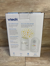 Front view of VTech TM8112 baby monitor box showing projector star graphic and parent and baby unit images on wood background