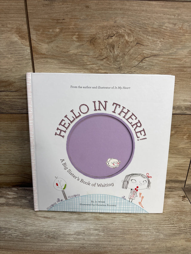 Front cover of Hello in There! hardcover children's book with purple circular peek-through and illustrated girl on wood background