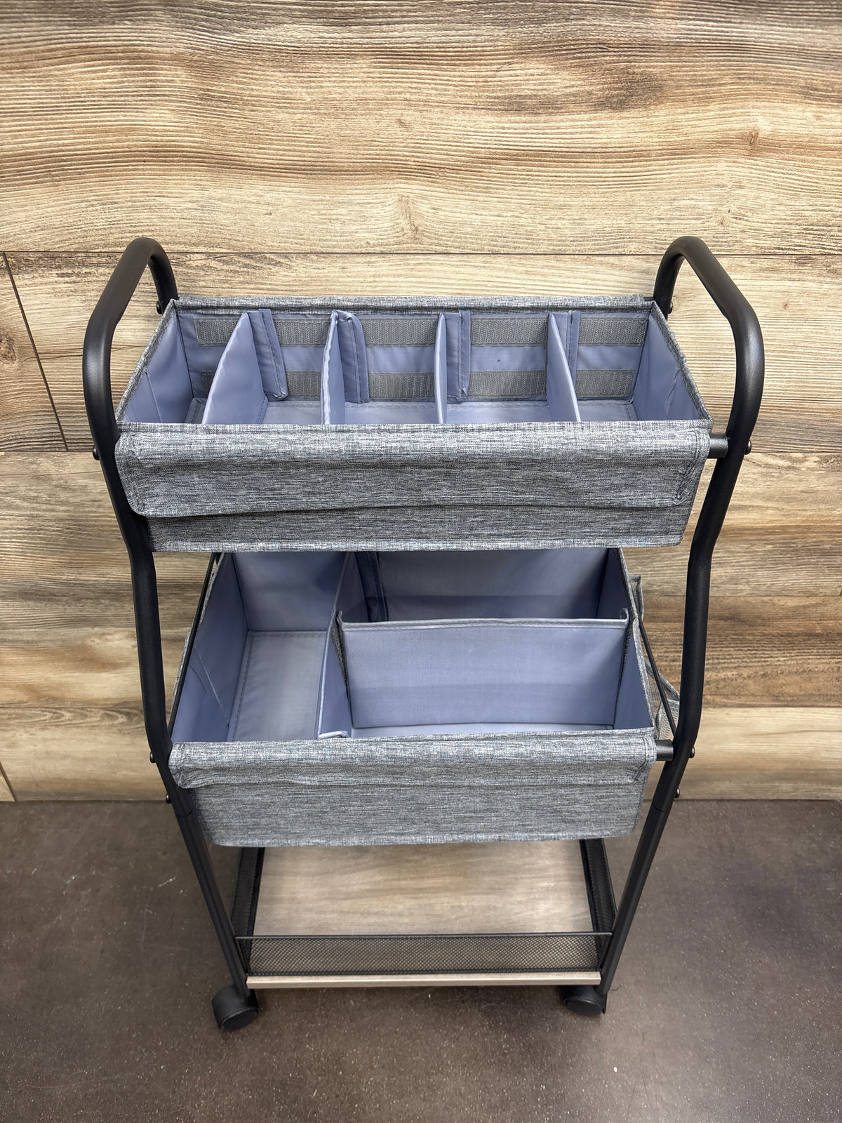 Front view of 3-tier baby diaper caddy organizer and storage cart showing divided gray baskets with black frame on wood floor