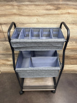 Front view of 3-tier baby diaper caddy organizer and storage cart showing divided gray baskets with black frame on wood floor