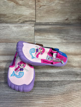 Three-quarter view of Newtz mermaid water shoes in purple and pink with embroidered mermaid and rubber toe on wood background