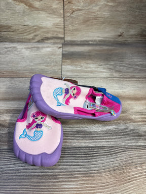 Three-quarter view of Newtz mermaid water shoes in purple and pink with embroidered mermaid and rubber toe on wood background