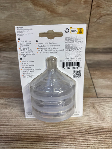 Front view of Boon NURSH fast flow silicone bottle nipples 3-pack showing stacked clear nipples in blister pack on wooden table