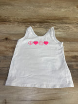 Front view of white toddler tank top with pink peace sign, two hearts, and smiley face graphic laid flat on wood background