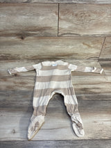 Striped baby footed onesie with soft grip soles on wooden floor